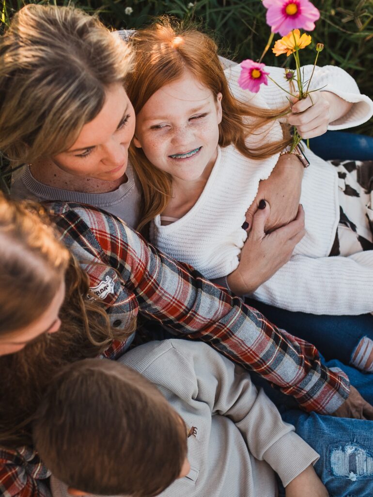 family photo with girl holding wildflowers at parker flower farms in elkton florida