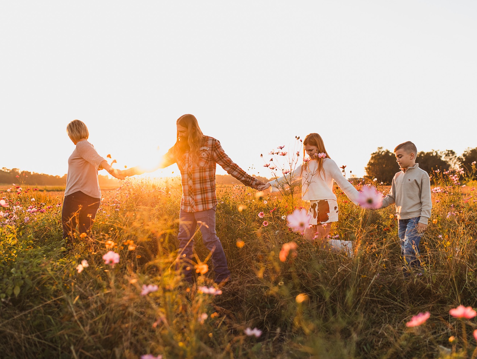 Family walking in field of wildflowers at Parker Flower Farm in Elkton, FL.