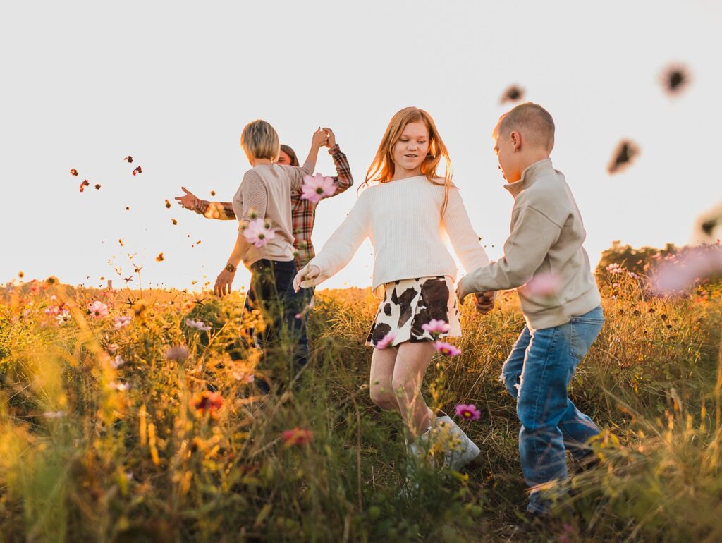 Family dancing in field of flowers at parker flower farms in elkton florida