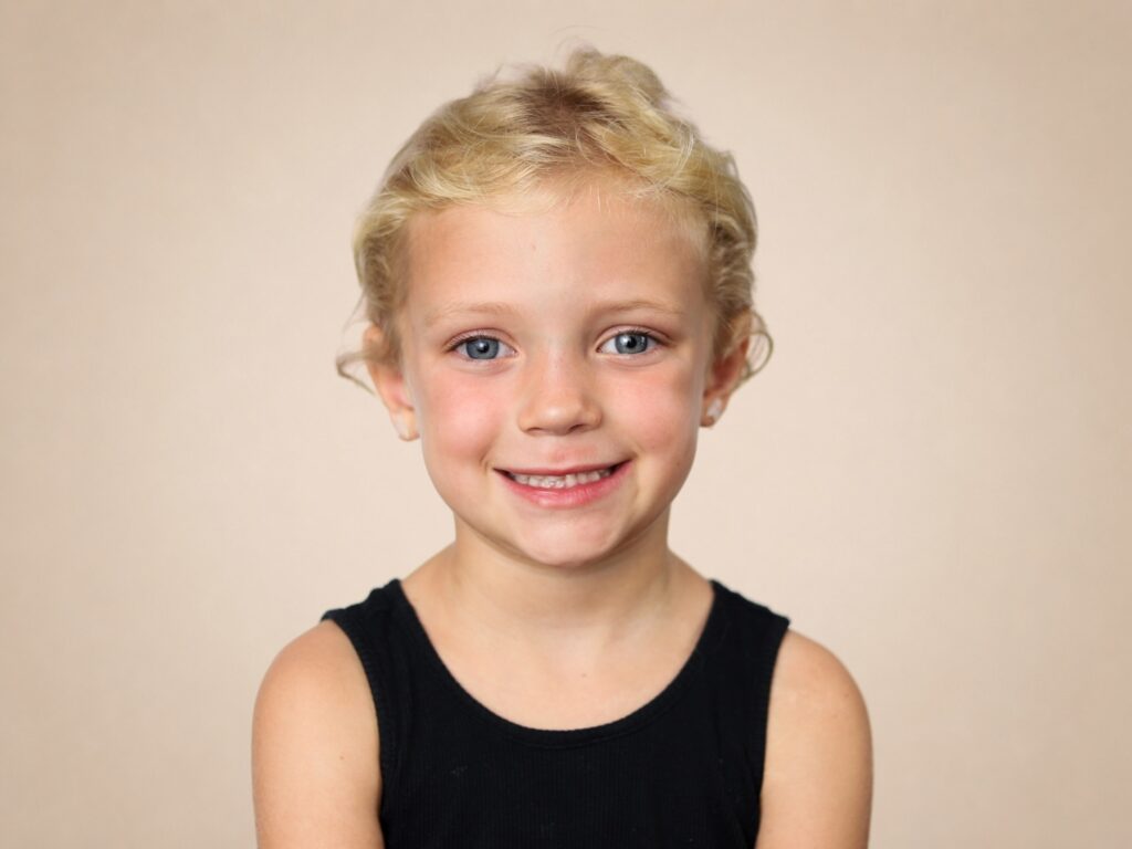 Preschool girl smiles for the camera on picture day in Jacksonville, Florida. 